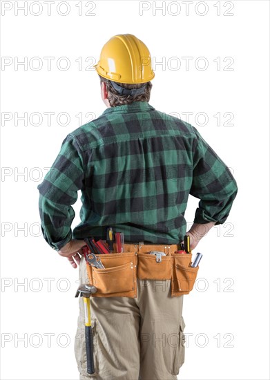 Male contractor with hard hat and tool belt looking away isolated a a white background
