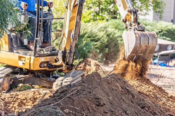 Working excavator tractor digging A trench at construction site