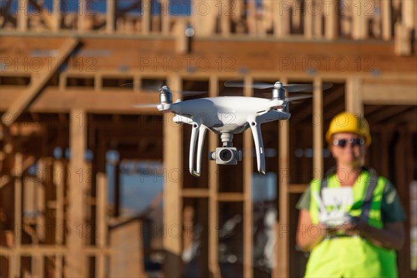 Female pilot flies drone quadcopter inspecting construction site