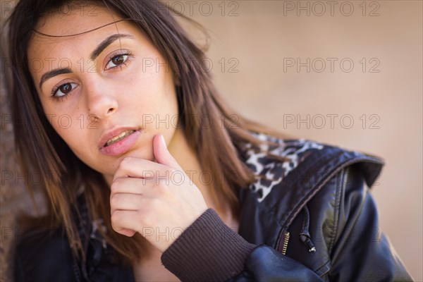 Beautiful meloncholy mixed-race young woman portrait outside