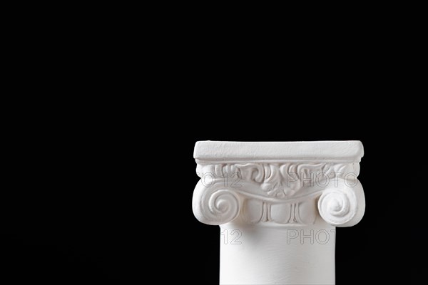 White ionic design column on dark background