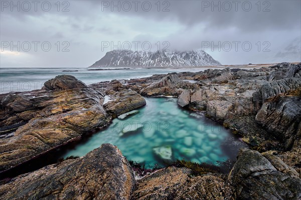 Rocky coast of fjord of Norwegian sea in winter. Lofoten islands