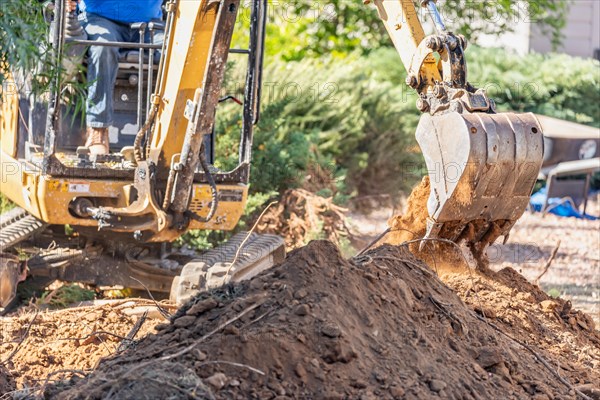 Working excavator tractor digging A trench at construction site