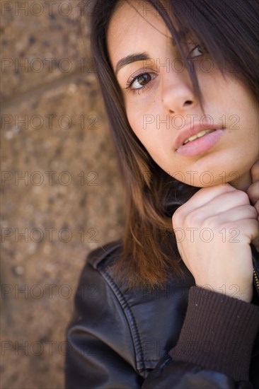 Beautiful meloncholy mixed-race young woman portrait outside