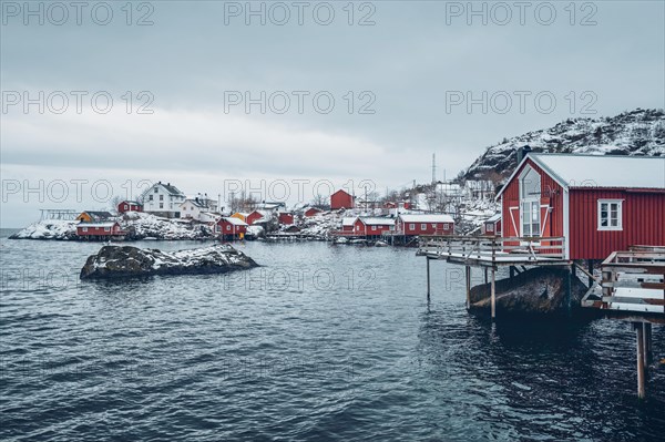 Nusfjord authentic traditional fishing village with traditional red rorbu houses in winter in Norwegian fjord. Lofoten islands