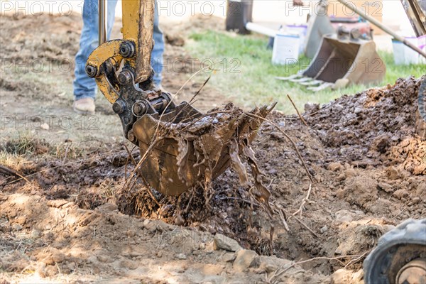 Working excavator tractor digging A trench at construction site