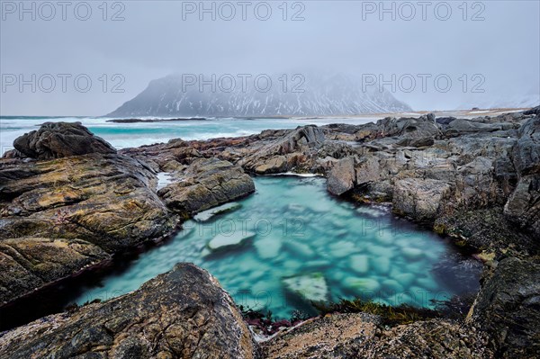 Rocky coast of fjord of Norwegian sea in winter. Lofoten islands