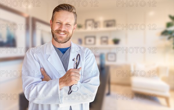 Handsome young adult male doctor with beard inside office