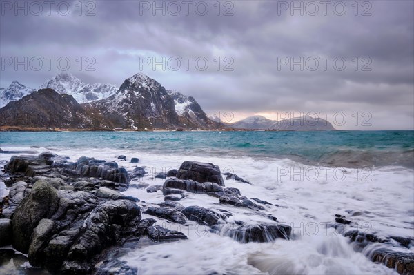 Rocky coast of fjord of Norwegian sea in winter. Vareid