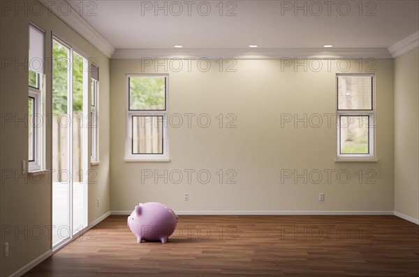 Piggy bank sitting on the floor of empty room of house with blank wall