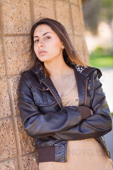 Beautiful meloncholy mixed-race young woman portrait outside