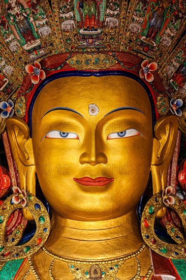 Maitreya Buddha statue face close up in Thiksey Gompa. Ladakh