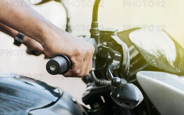 Hands of a person on the handlebar of a motorcycle