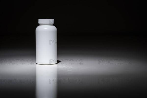 Blank white bottle ready for your text under spot light