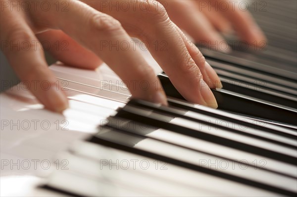 Woman's fingers on digital piano keys