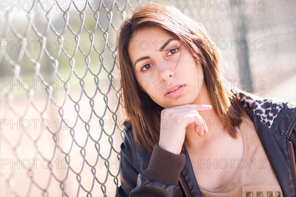 Beautiful meloncholy mixed-race young woman portrait outside