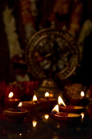 Diwali lights oil candles with Shiva Nataraja in the background for Maha Shivaratri