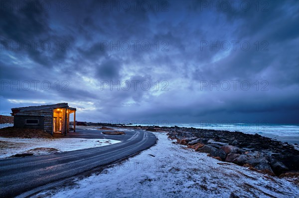 Shack on coast of Norwegian sea in fjord. Skagsanden beach