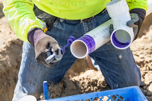 Plumber applying pipe cleaner