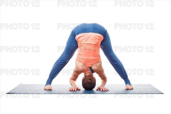 Beautiful sporty fit woman practices Ashtanga Vinyasa yoga asana Prasarita padottanasana A