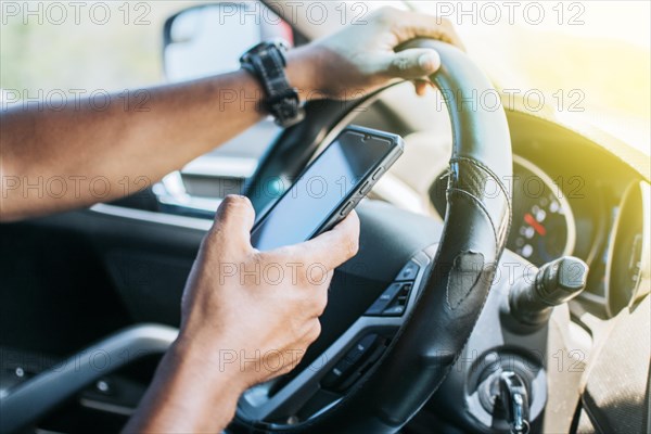 Person in his car using cell phone