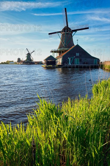 Windmills at famous tourist site Zaanse Schans in Holland on sunset. Zaandam