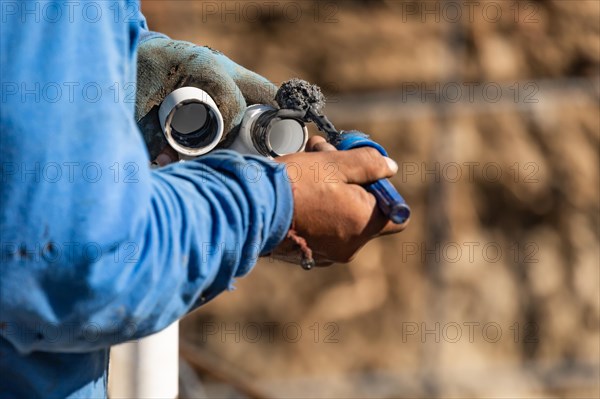 Plumber applying pipe cleaner