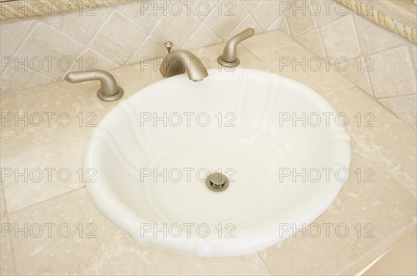 Shell shaped sink and faucet and tile counter
