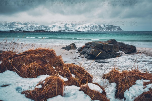 Waves of Norwegian sea on rocky beach of fjord. Ramberg beach