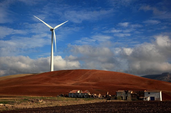 Windmill and dilapidated houses in front of it