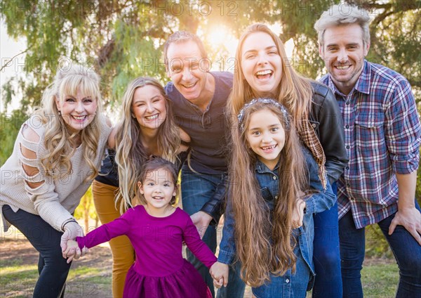 Multigenerational mixed-race family portrait outdoors