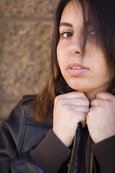 Beautiful meloncholy mixed-race young woman portrait outside