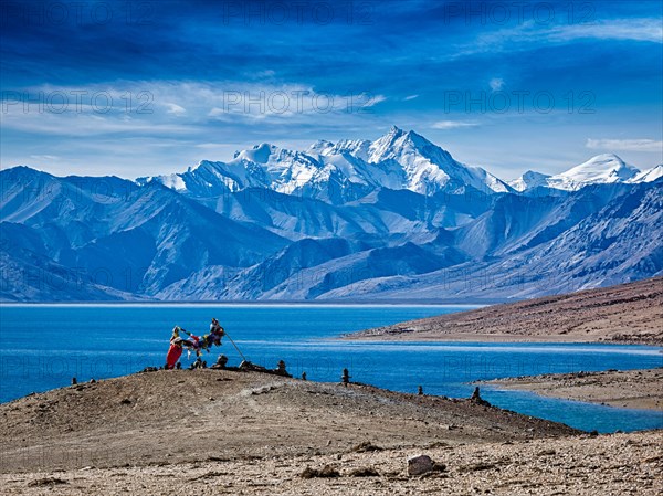 Buddhist prayer flags lungta at Himalayan lake Tso Moriri in the morning. Korzok