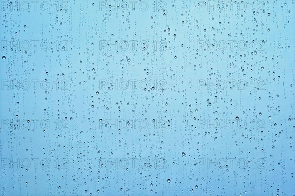 Rain water drops droplets on window glass texture background