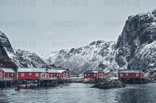 Nusfjord authentic traditional fishing village with traditional red rorbu houses in winter in Norwegian fjord. Lofoten islands