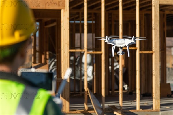 Female pilot flies drone quadcopter inspecting construction site