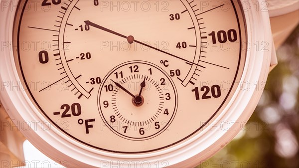 Round thermometer showing over 110 degrees