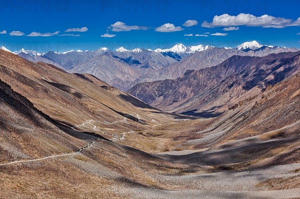 View of Karakorum range and road in valley from Kardung La