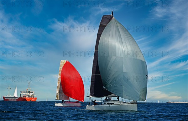 Sailboats with red and grey sails