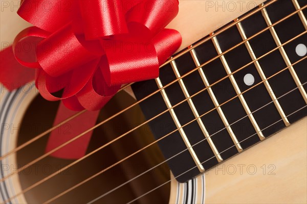 Guitar strings with red ribbon