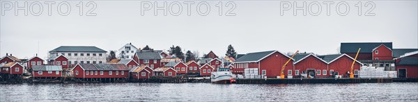 Panorama of Reine fishing village on Lofoten islands with red rorbu houses