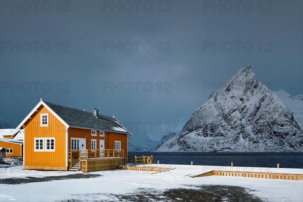 Yellow traditional rorbu house in Sakrisoy fishing village in winter on Lofoten Islands