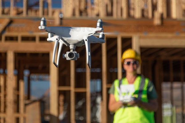 Female pilot flies drone quadcopter inspecting construction site