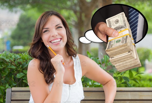 Thoughtful young woman with hand holding stack of money inside thought bubble