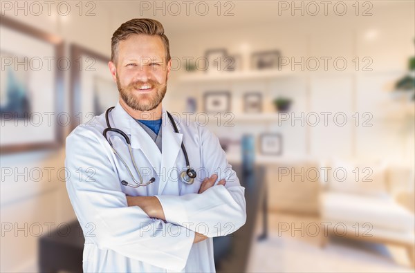 Handsome young adult male doctor with beard inside office