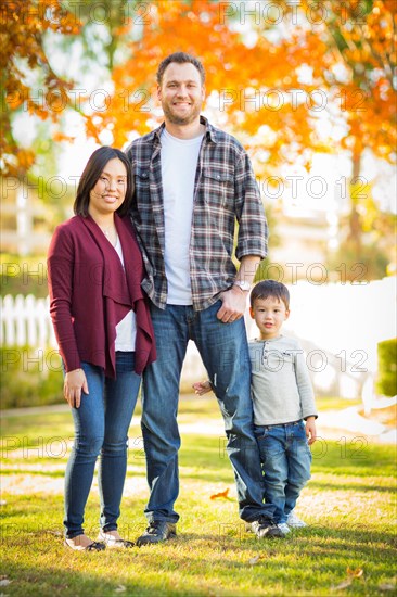 Outdoor portrait of mixed-race chinese and caucasian parents and child