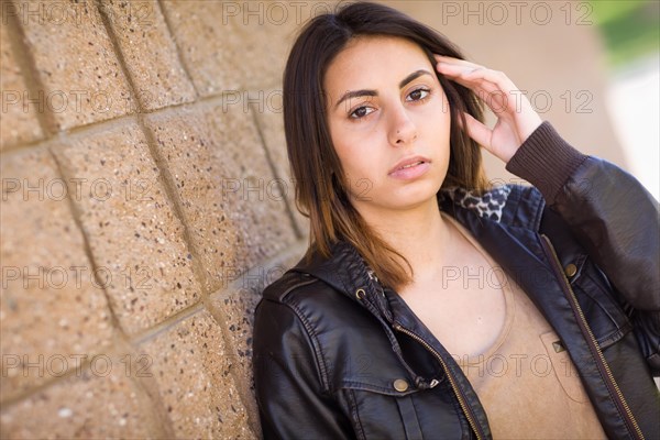 Beautiful meloncholy mixed-race young woman portrait outside