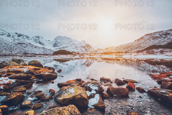 Sunset in Norwegian fjord in winter. Lofoten islands