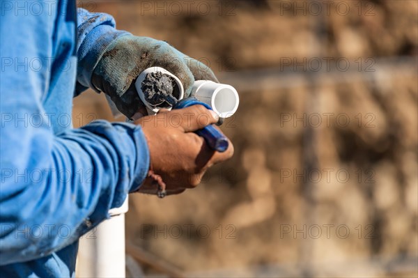 Plumber applying pipe cleaner