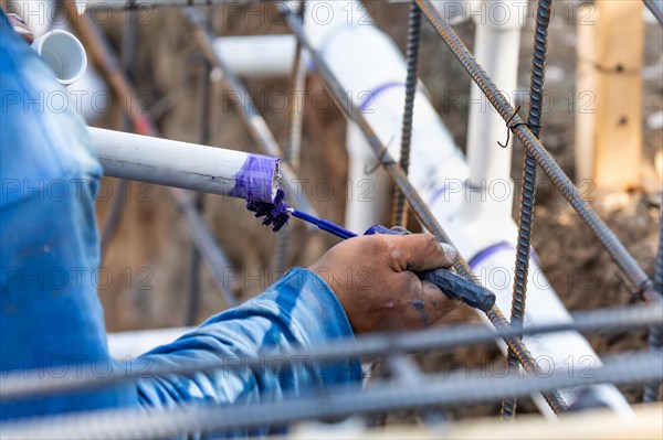 Plumber applying pipe cleaner